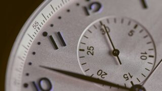 a close up of a silver watch face